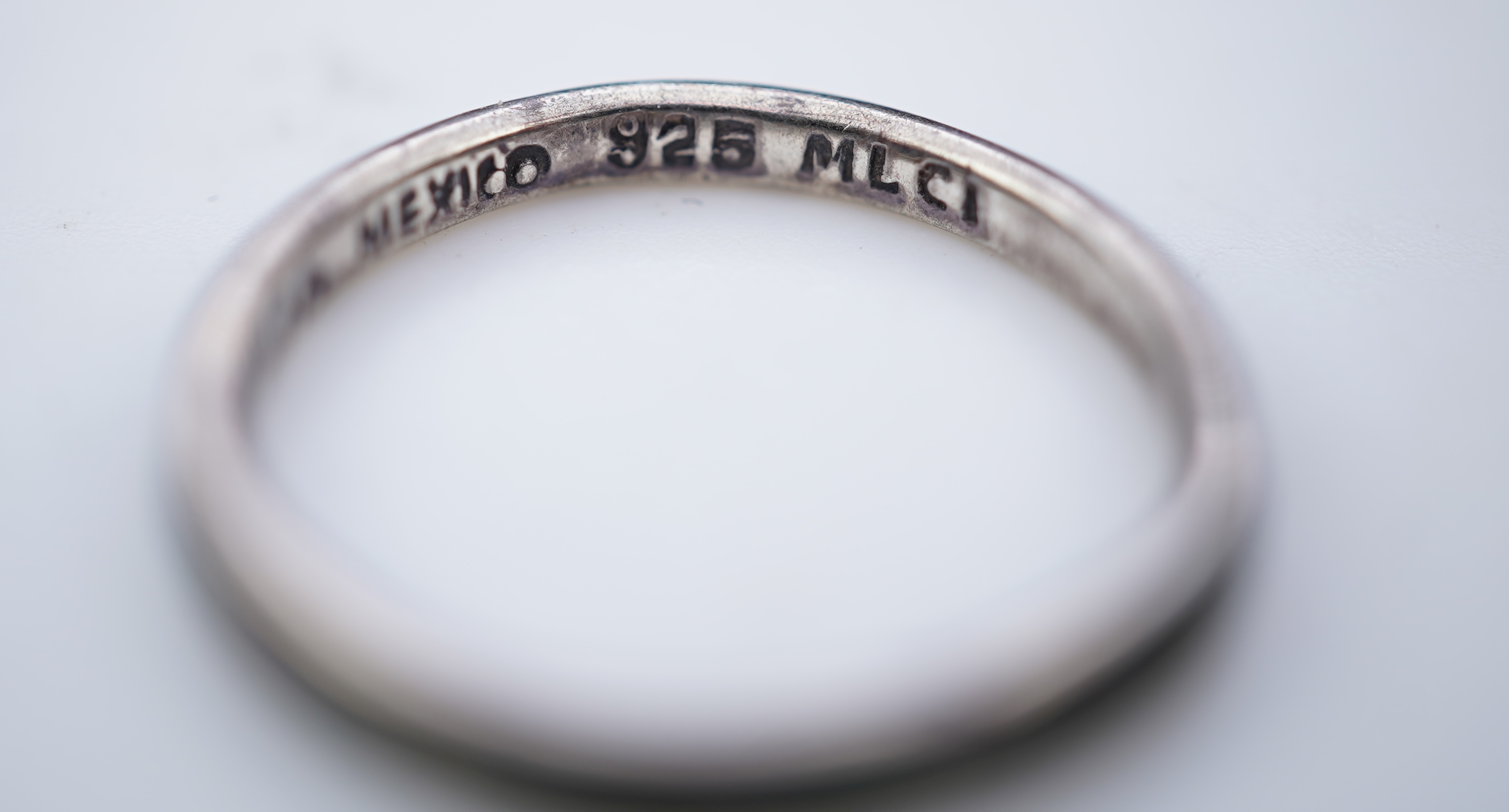 A collection of silver jewels, comprising: a bangle; a chain necklace suspending two winding toothpicks, one with toothpick deficient; a rope twist chain; a pair of cufflinks with the initials DBH; a pendant of abstract